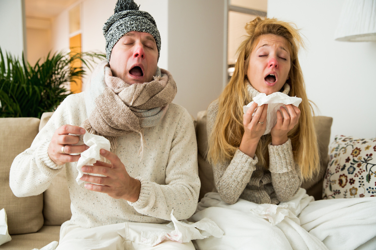Man and woman sneezing, coughing, got flu, having runny nose. 